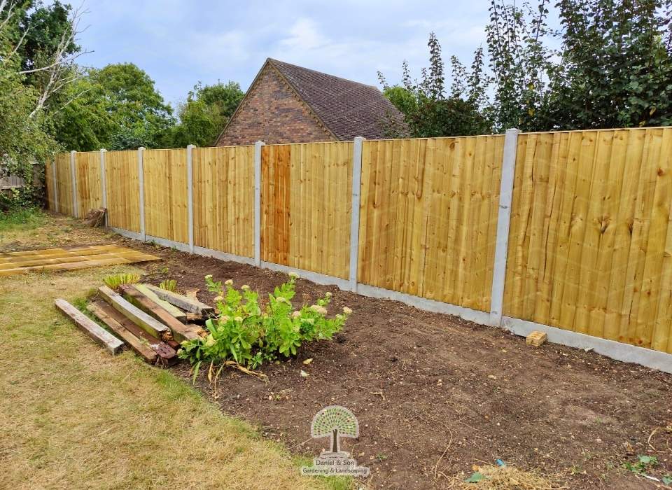 New closeboard fencing installation with concrete posts and gravel boards, enhancing garden privacy and security.